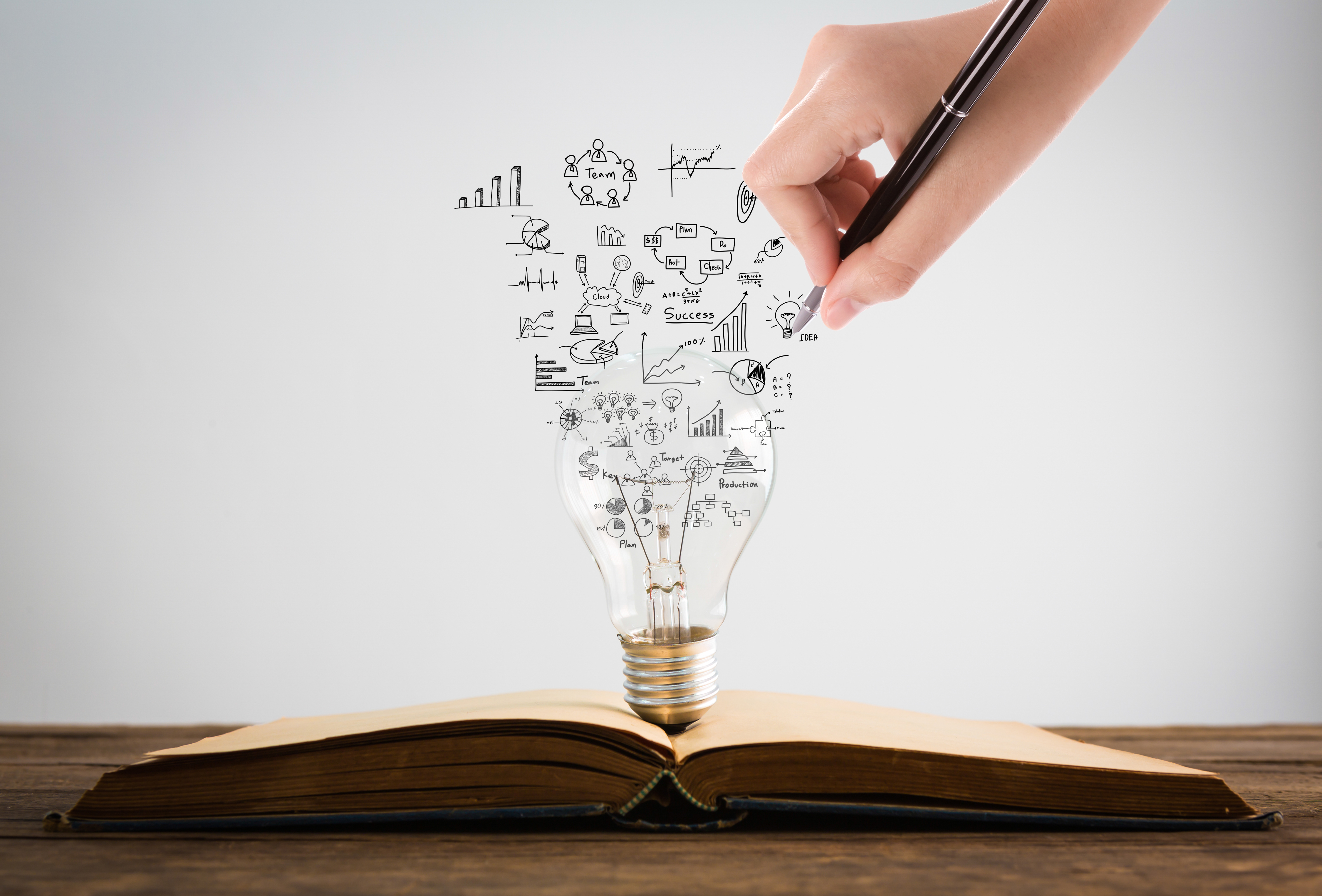 person-holding-light-bulb-with-graduation-cap