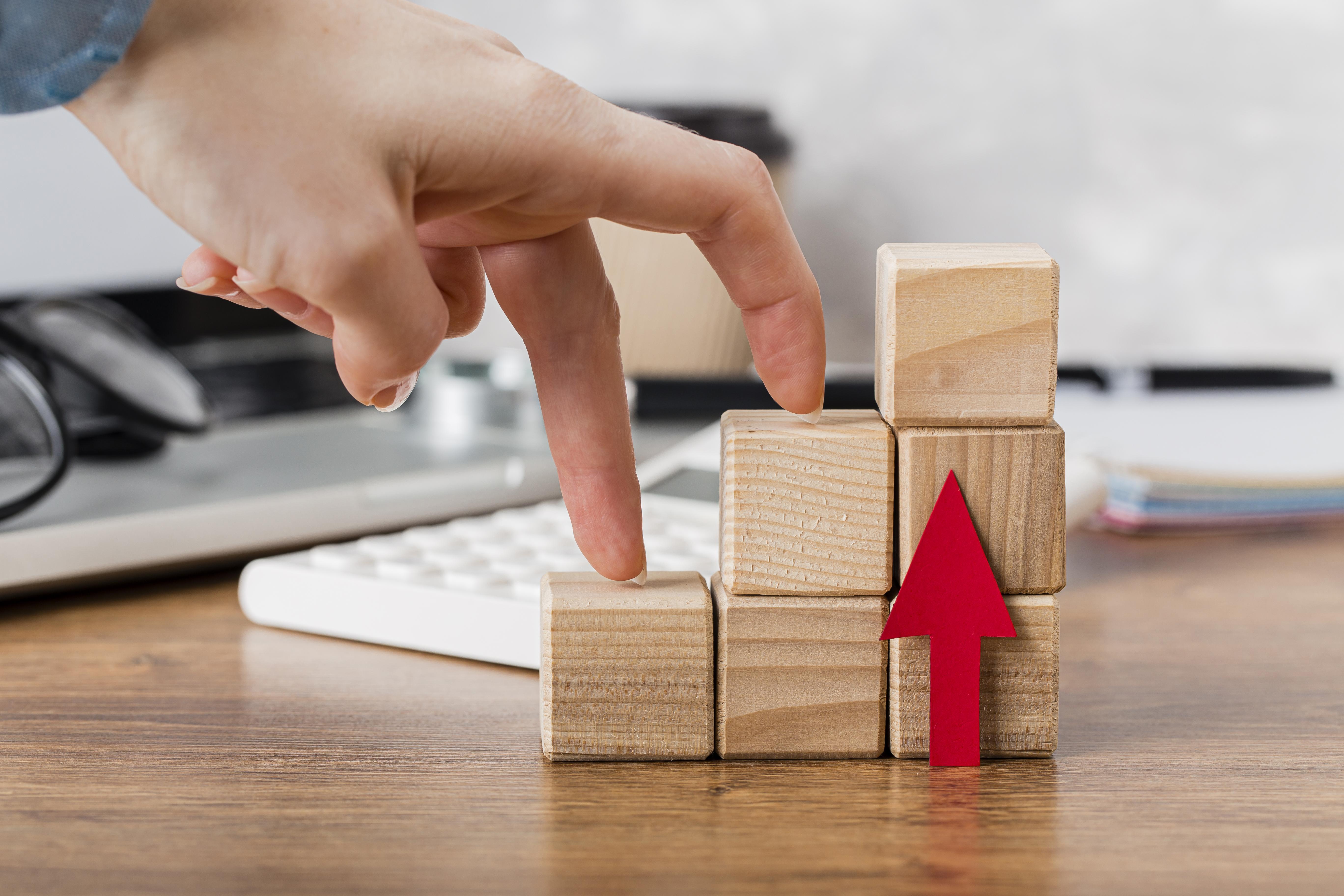 hand-climbing-wooden-blocks-represent-growth