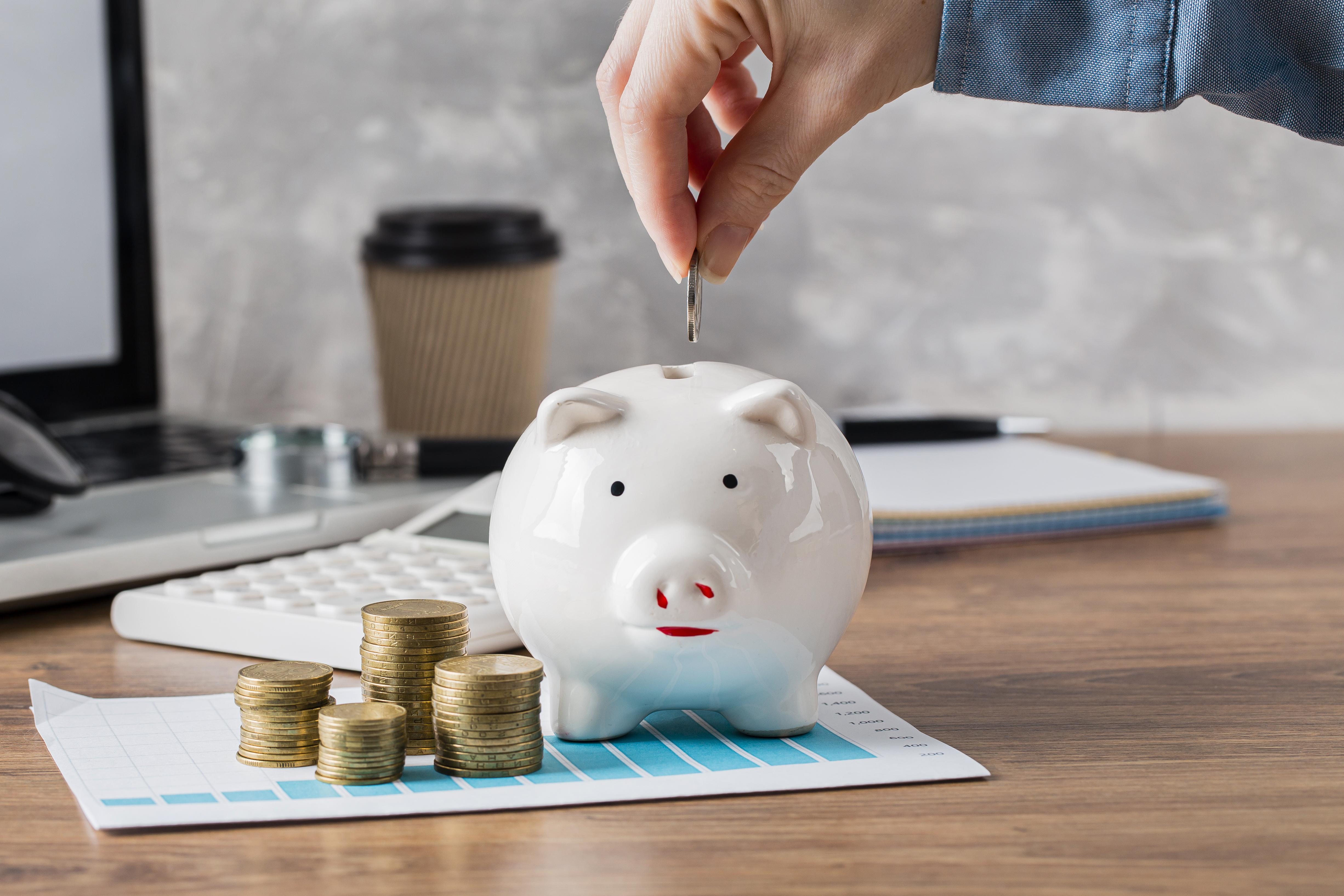 hand-putting-coin-piggy-bank