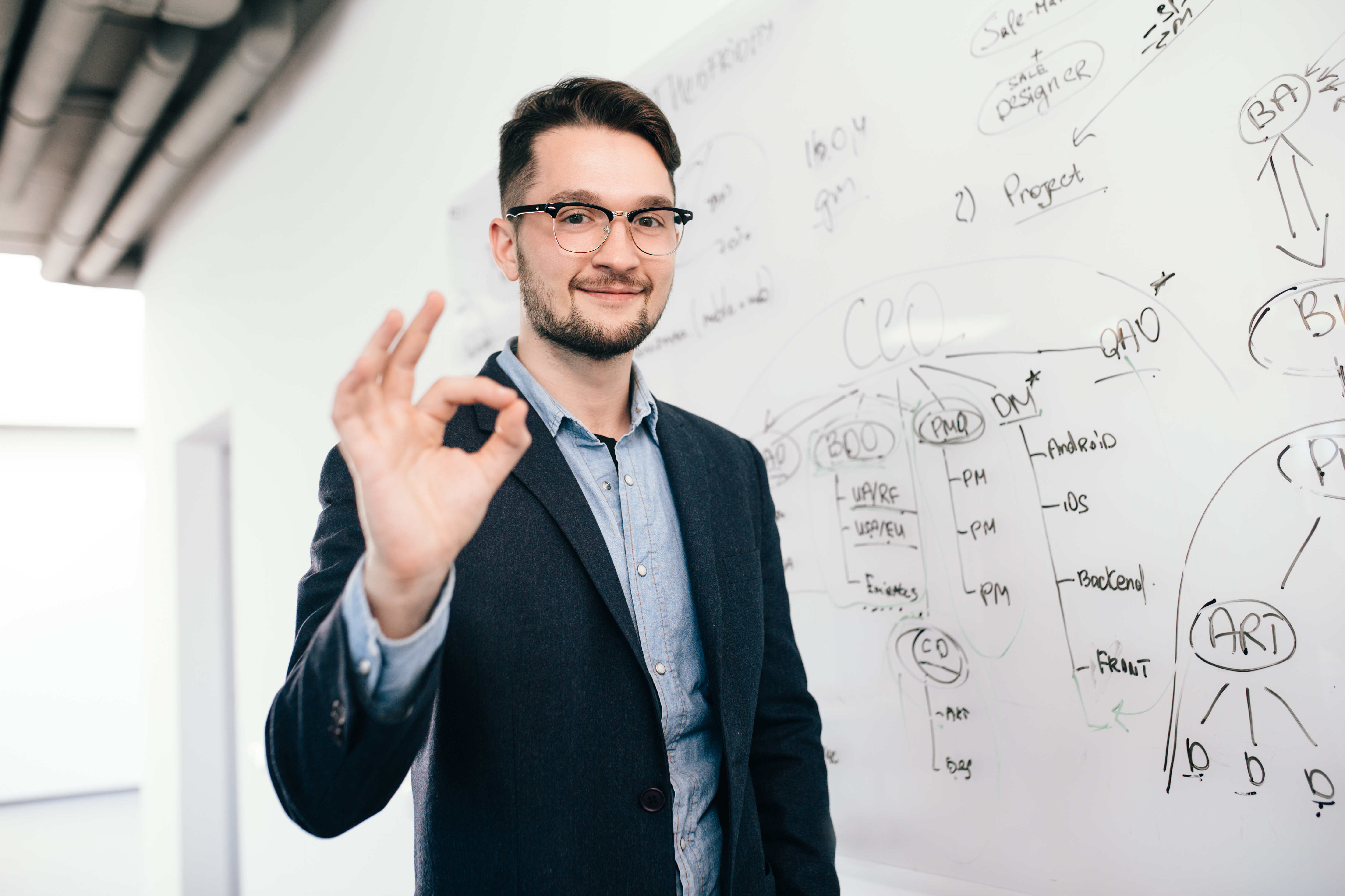 young-man-glasses-is-standing-near-whiteboard
