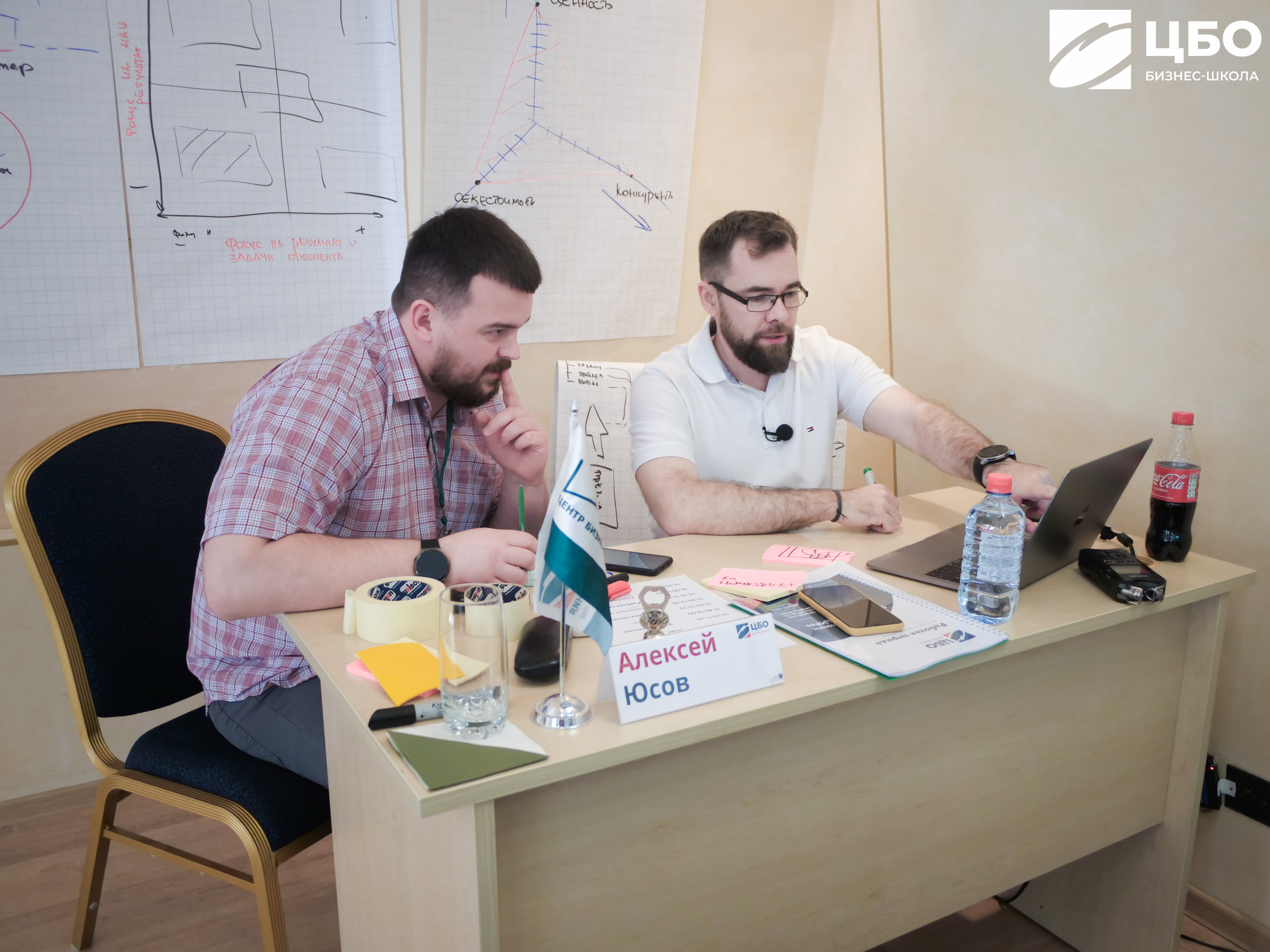 two-men-looking-at-a-laptop